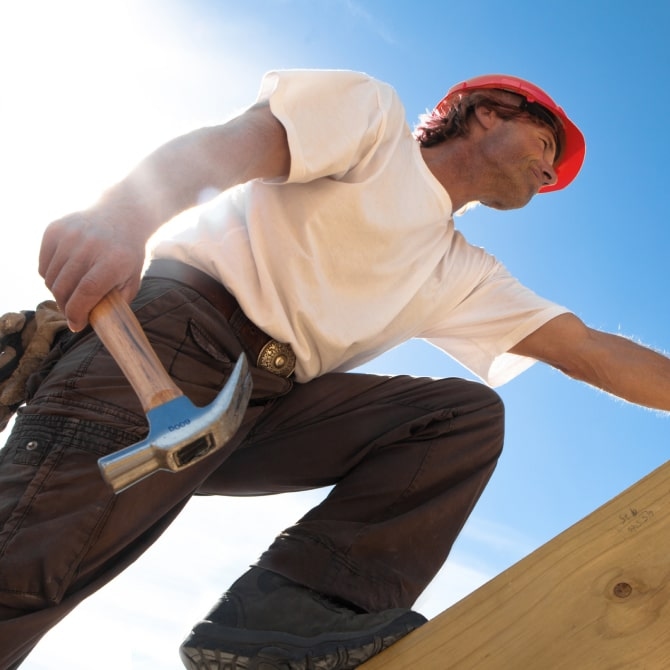 home service professional climbing the roof