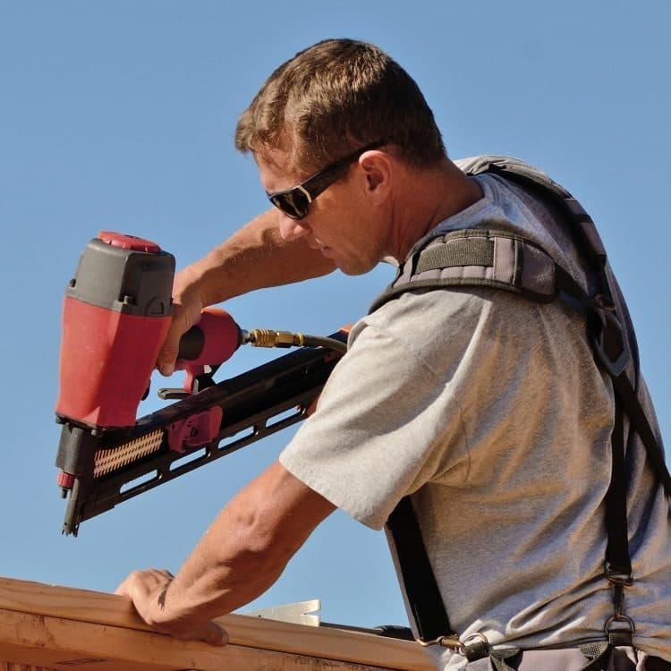 roofing professional climbing in the roof