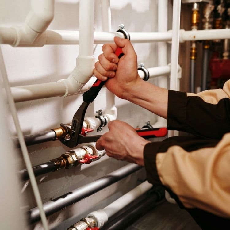 Plumber fixing the faulty pipeline