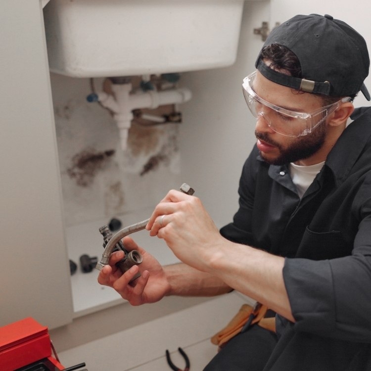 Plumber fixing the faulty pipeline