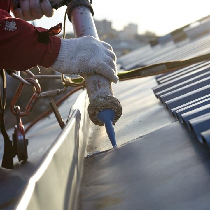 roofing professional climbing in the roof